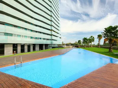 a large swimming pool in front of a building at Apartment Diagonal Mar by Interhome in Barcelona