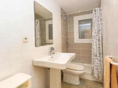 a white bathroom with a sink and a toilet at Apartment Eixample Dret Corsega Roger Lluria by Interhome in Barcelona