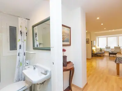 a bathroom with a sink and a mirror at Apartment Eixample Dret Corsega Roger Lluria by Interhome in Barcelona