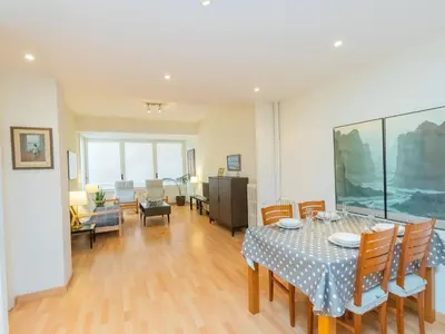 a dining room with a table and chairs and a living room at Apartment Eixample Dret Corsega Roger Lluria by Interhome in Barcelona