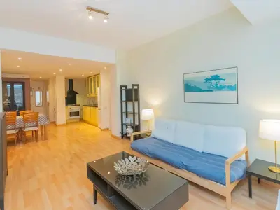 a living room with a couch and a table at Apartment Eixample Dret Corsega Roger Lluria by Interhome in Barcelona