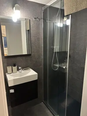 a bathroom with a sink and a glass shower at Apartment Eixample Dret Aragon - Sardenya in Barcelona