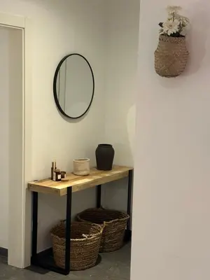 a bathroom with a table with a mirror and baskets at Apartment Eixample Dret Aragon - Sardenya in Barcelona