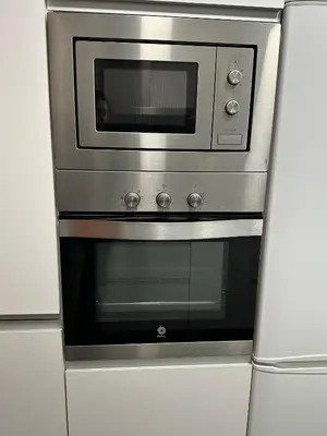 a stainless steel oven in a white kitchen at Apartment Eixample Dret Aragon - Sardenya in Barcelona
