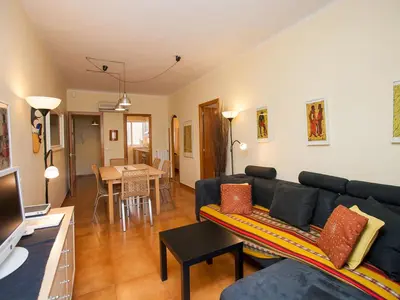 a living room with a couch and a table at Apartment Sardenya - Casp by Interhome in Barcelona