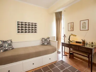 a bedroom with a bed with a desk and a desk at Apartment Sardenya - Casp by Interhome in Barcelona