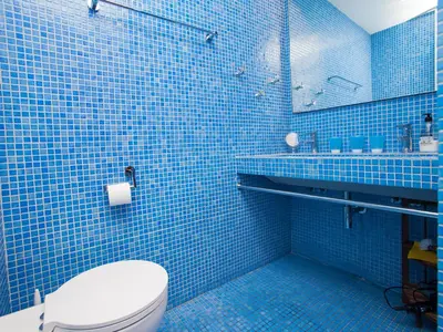 a blue tiled bathroom with a toilet and a sink at Apartment Sardenya - Casp by Interhome in Barcelona