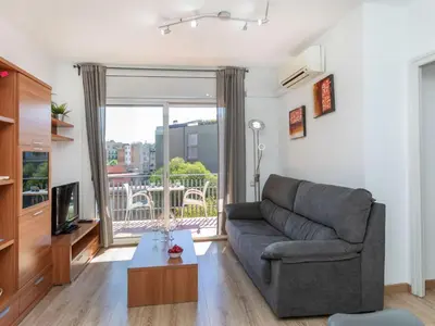 a living room with a couch and a television at Apartment Eixample Esq Rocafort Diputacio by Interhome in Barcelona