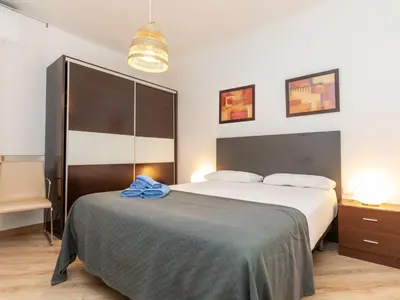 a bedroom with a bed with a blue towel on it at Apartment Eixample Esq Rocafort Diputacio by Interhome in Barcelona