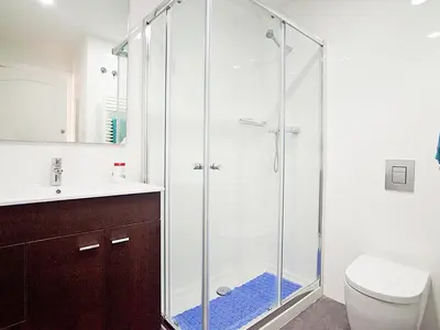 a glass shower in a bathroom with a toilet at Apartment Eixample Esquerre Gran Via Balmes by Interhome in Barcelona