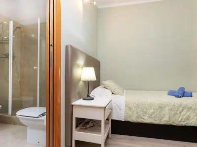 a small bedroom with a bed and a shower at Apartment Sants-Montjuic Rambla Badal by Interhome in Barcelona
