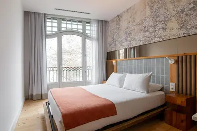 a bedroom with a bed and a large window at Gòtic by The 5ve Soul in Barcelona
