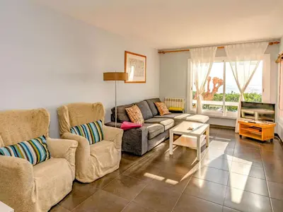 a living room with two chairs and a couch and a tv at Apartment Blaumar by Interhome in Sant Andreu de Llavaneres