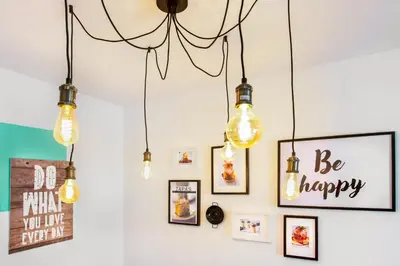 a group of lights hanging on a wall with pictures at Stay U-nique Apartments Ricart in Barcelona