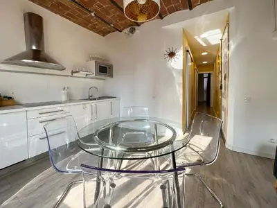 a glass table and chairs in a kitchen at Stay U-nique Apartments Fontrodona in Barcelona