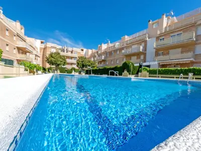 a swimming pool with blue water in a building at Apartment Aires de mar by Interhome in Cunit