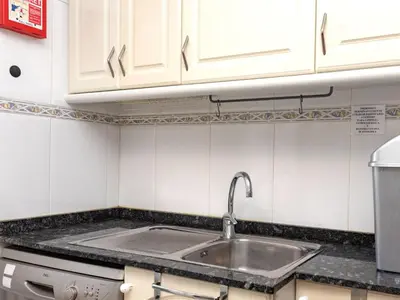 a kitchen with a sink and white cabinets at Apartment Aires de mar by Interhome in Cunit