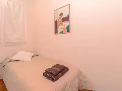 a bedroom with a bed with a towel on it at Apartment Eixample Esquerre Arago Rocafort by Interhome in Barcelona