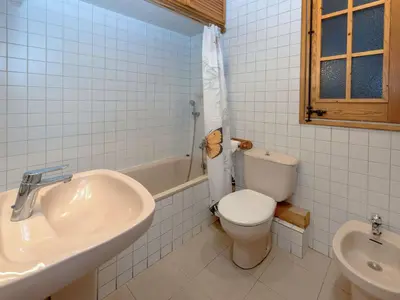 a white bathroom with a sink and a toilet at Apartment Eixample Esquerre Arago Rocafort by Interhome in Barcelona