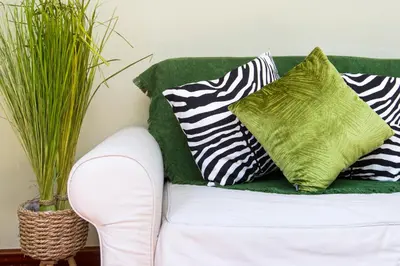 a white couch with pillows on it with plants at Stay U-nique Apartments Provença II in Barcelona