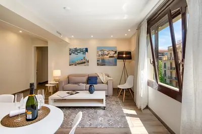 a living room with a couch and a table at Eixample Building Apartments by Mercedes Heritage in Barcelona