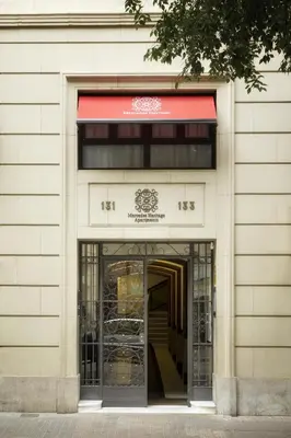 an entrance to a building with a red awning at Eixample Building Apartments by Mercedes Heritage in Barcelona