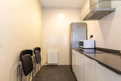 a waiting room with a microwave and a refrigerator at Alos Apartments Paseo de Gracia-Diagonal in Barcelona