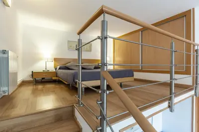 a bedroom with a bunk bed and a staircase at Alos Apartments Paseo de Gracia-Diagonal in Barcelona
