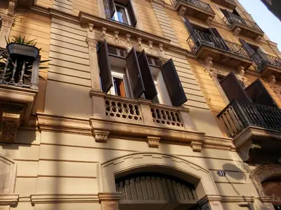a building with windows and balconies on it at Barcelona Central Garden Hostal in Barcelona