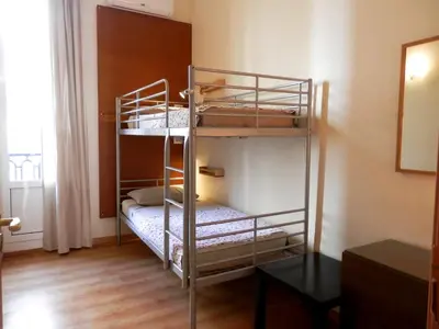 a bunk bed room with two bunk beds in it at Barcelona Central Garden Hostal in Barcelona
