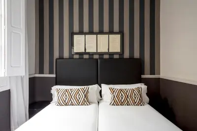a bedroom with a bed with two pillows on it at Barcelona Apartment Val in Barcelona