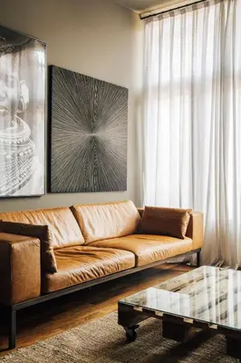 a living room with a brown couch and a coffee table at Barcelona Apartment Val in Barcelona