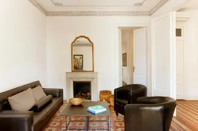 a living room with a couch and chairs and a fireplace at Barcelona Apartment Val in Barcelona