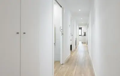 a hallway with white walls and wooden floors at Stay U-nique Apartments Fabra i Puig in Barcelona