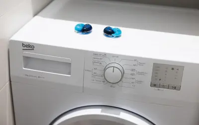a washing machine with blue buttons on top of it at Stay U-nique Apartments Fabra i Puig in Barcelona