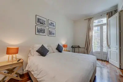 a bedroom with a large white bed and a window at BCN Apartments 41 in Barcelona