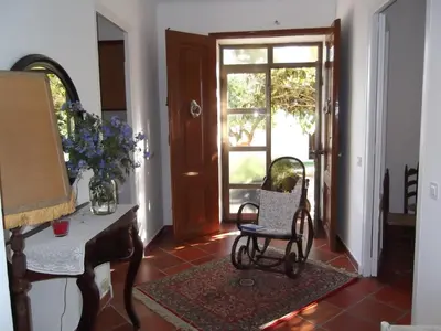 a living room with a chair and a piano at Mas Cabrit in Les Franqueses del Vallès
