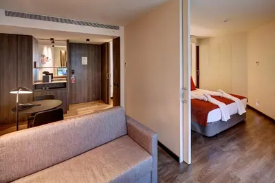 a hotel room with a bed and a couch at Olivia Balmes Hotel in Barcelona