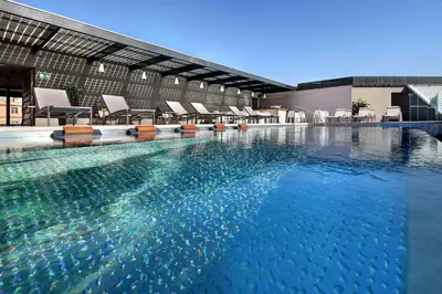 a large swimming pool with chairs in a building at Olivia Balmes Hotel in Barcelona