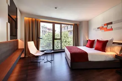 a hotel room with a bed and a large window at Olivia Balmes Hotel in Barcelona