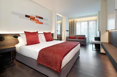 a bedroom with a large bed with red pillows at Olivia Balmes Hotel in Barcelona