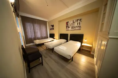 a hospital room with two beds and a chair at Wow Hostel Barcelona in Barcelona