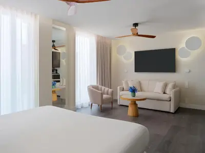a hotel room with a bed and a couch at H10 Port Vell 4* Sup in Barcelona