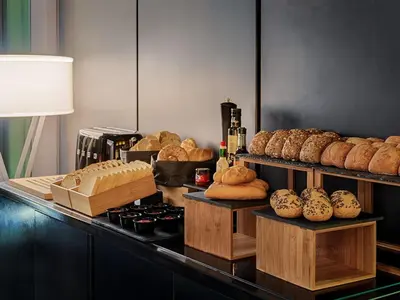 a counter with bread and other items on it at H10 Port Vell 4* Sup in Barcelona