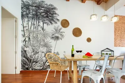 a dining room with a palm mural on the wall at Stay U-nique Apartments Girona in Barcelona