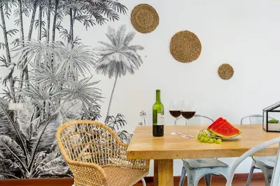 a table with a bottle of wine and two glasses of wine at Stay U-nique Apartments Girona in Barcelona