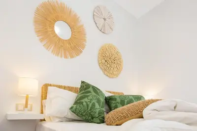 a room with a couch with pillows and mirrors on the wall at Stay U-nique Apartments Girona in Barcelona