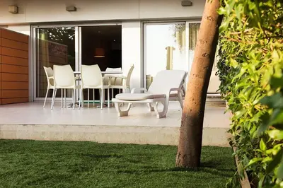 a group of chairs and a table on a patio at Apartaments Maritim in Castelldefels