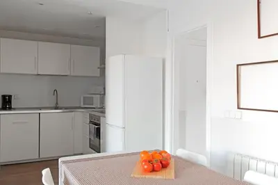 a kitchen with a table with tomatoes on a cutting board at My Address in Barcelona Old Town in Barcelona