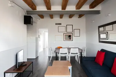a living room with a blue couch and a table at My Address in Barcelona Old Town in Barcelona